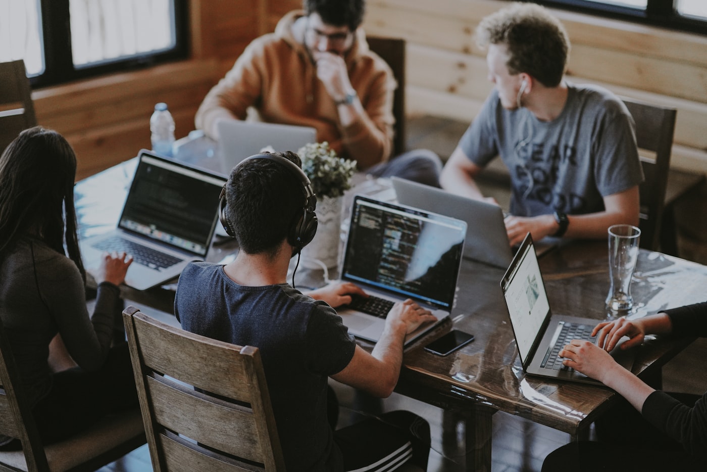 Software engineers collaborating around a laptop in a modern office